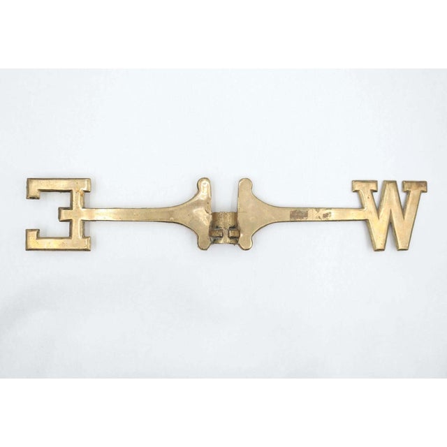 This is a solid brass weathervane directional crossbar, representing the West and East compass cardinal points. The North-...