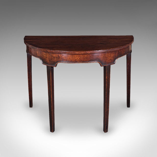 This is an antique demi lune console table. An English, mahogany alcove or pier table in Hepplewhite taste, dating to the...