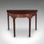 This is an antique demi lune console table. An English, mahogany alcove or pier table in Hepplewhite taste, dating to the...