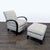 This Room & Board lounge chair features a soft, light grey fabric and striking curved dark wood arms. The chair is...