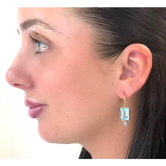 Emerald cut Blue Topaz is paired with faceted Tanzanite for this new favorite earring