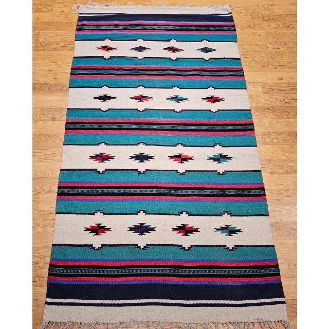 This vintage Southwestern kilim rug, part of our curated Americana Collection, features a bold and balanced design with...