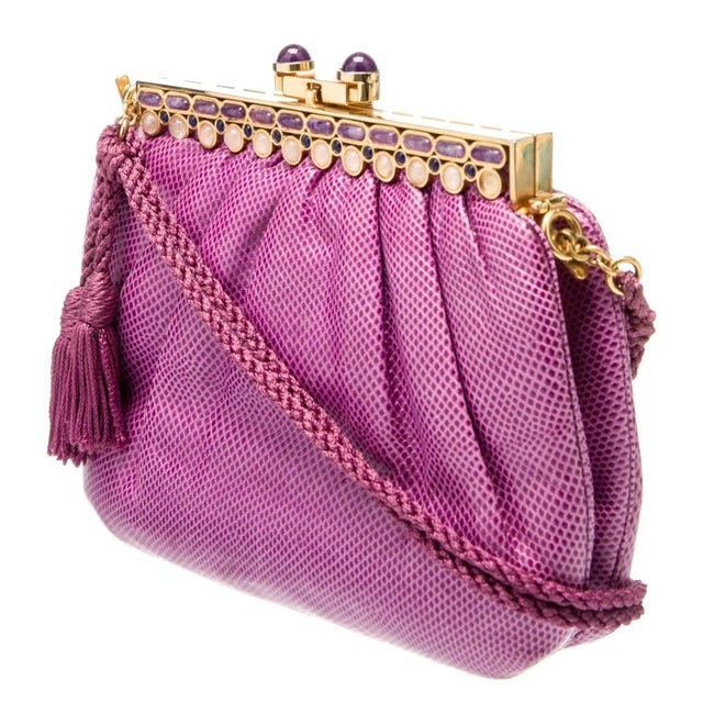 This vintage Judith Leiber fuchsia pink karung snakeskin evening bag features a stunning gold-plated frame embellished...