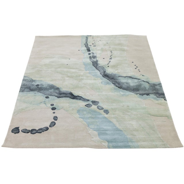 Transform your living space with this modern hand-tufted wool rug featuring an abstract design that echoes watercolor...