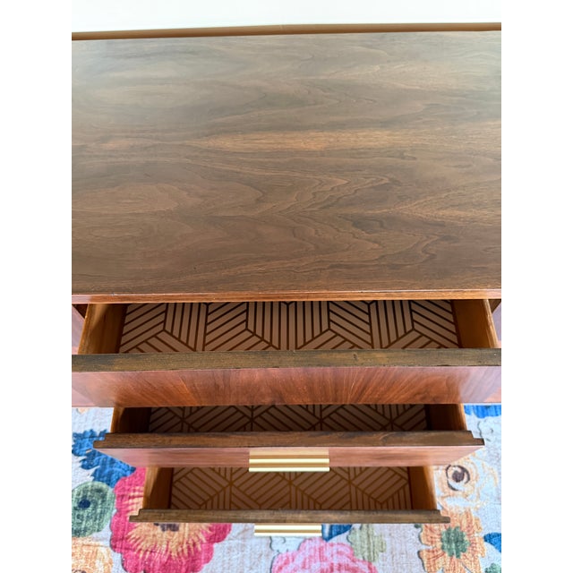 A striking 1960s lowboy dresser from Stanley Furniture's "Distinctive Furniture" line, fully restored to showcase the rich...