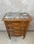 A charming Louis XVI style chest of drawers dating from the 1920s, crafted from walnut and topped with an elegant veined...