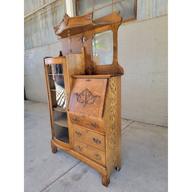 American Golden Oak era antique tiger oak side by side circa. 1890-1910. Featuring a bow front glass display cabinet,...