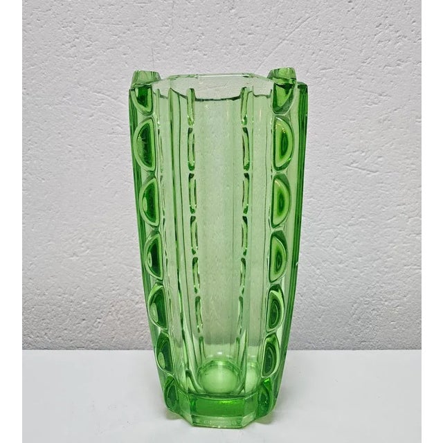 In this listing you will find a beautiful Art Deco green glass vase. It's done in beautiful light green glass and features...
