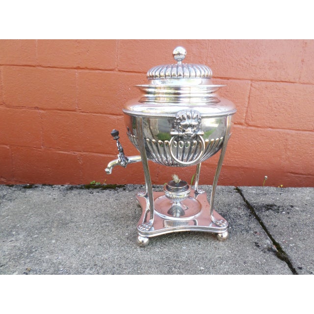 An English Regency Sheffield Hot Water Urn, silver over copper, hand made around 1820-30, the ribbed dome lid over a round...