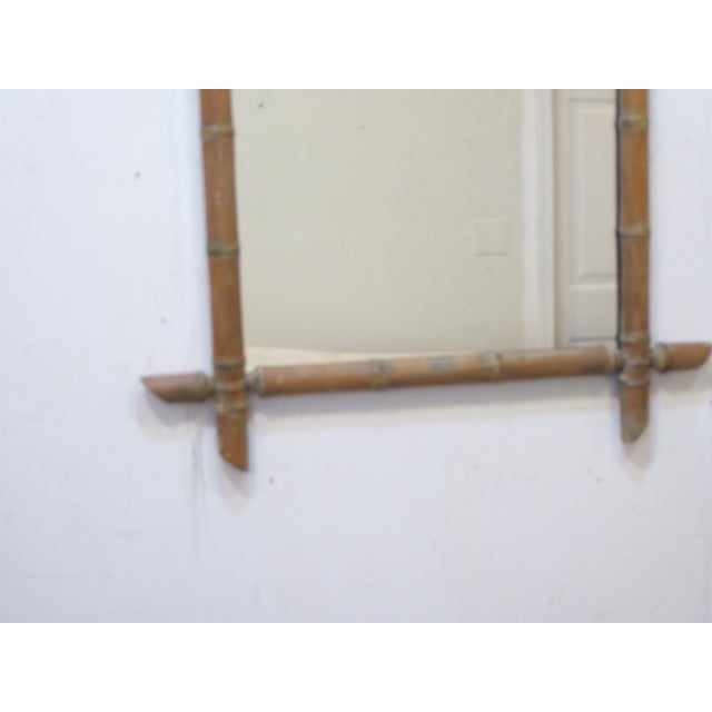 This weathered bamboo mirror measures 31"H x 24"W.