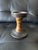 Striking handcrafted candlestick with a primitive, sculptural character. The substantial charcoal-black circular base and...