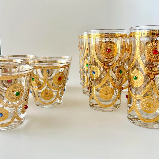 A dazzling and rare Mid-Century Modern Culver Ltd. “Jeweled Ornaments” glassware set, richly decorated in raised 22-karat...