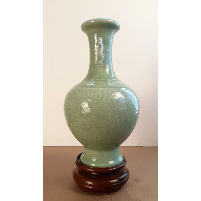 Chinese celadon floral haitangzun vase, a garlic headed vase, covered by a celadon glaze on the exterior and interior and...