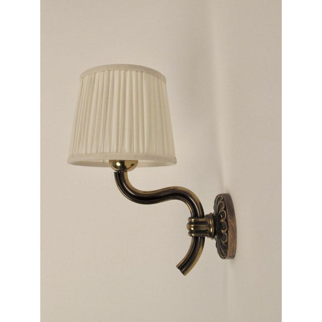 A set of three wall lights designed by Hugo Gorge in the 1930's. Crafted with remarkable skill using pressure casting, the...