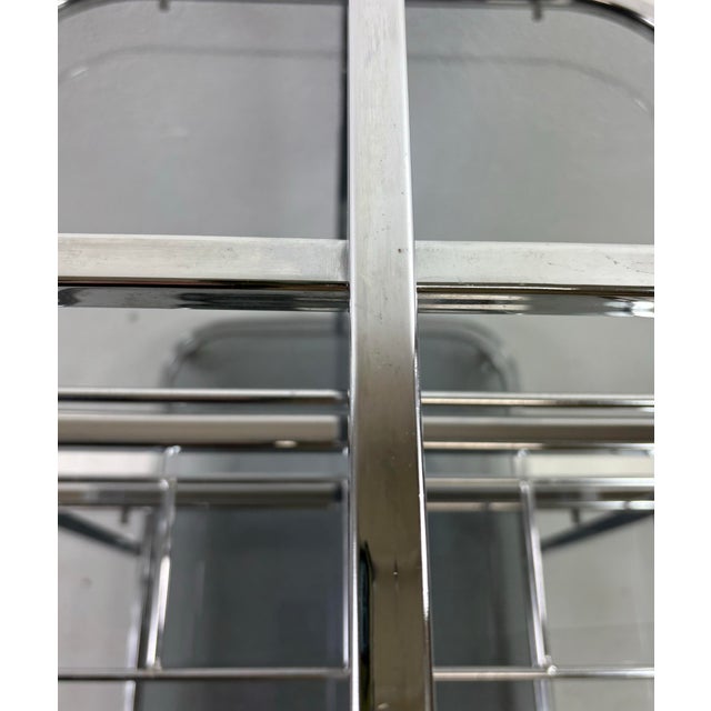 This is an early 20th century chrome and smoked glass bar trolley. This bar trolley has a classic art deco style in shiny...