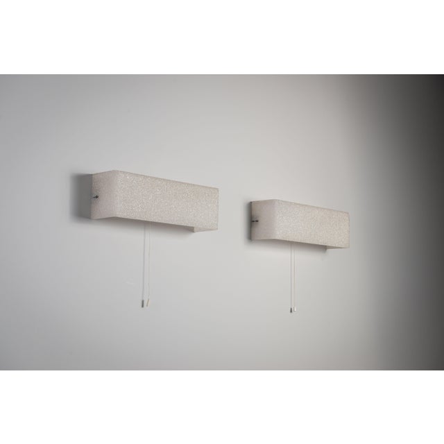 This beautiful vintage pair of Cristallux wall lamps features striking rectangular shades crafted from a unique frosted-...