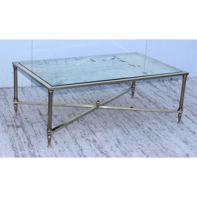 1950s modern solid brass French coffee table with antique mirror top.