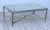 1950s modern solid brass French coffee table with antique mirror top.
