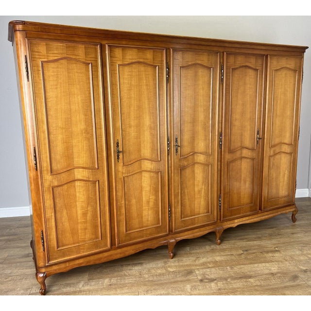 An exceptional Vintage French Louis wardrobe of grand proportions, showcasing elegant craftsmanship with beautifully...