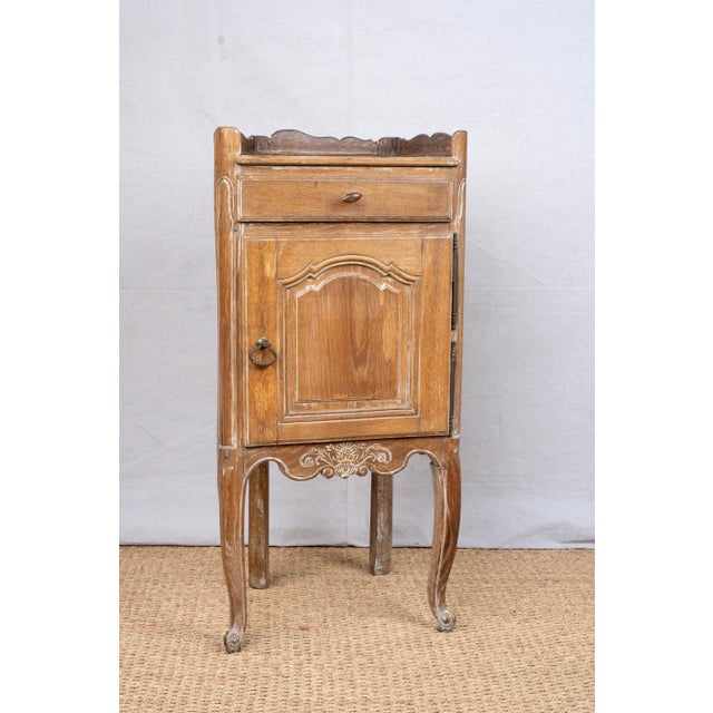 A small corner cabinet or encoignure, c. 1850, French. Made from solid oak with a limewashed finish, most likely for a...