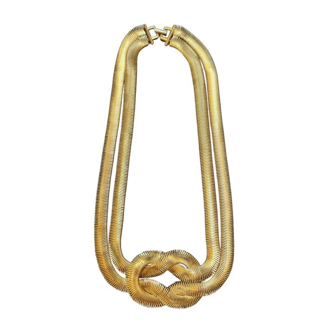 This necklace is from an estate sale in Montecito. It is a timeless gold-tone knotted snake chain necklace featuring...