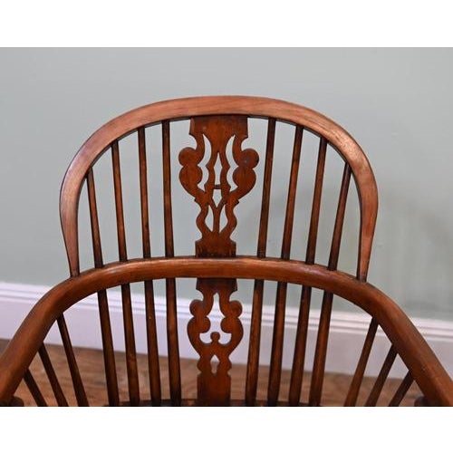 Attractive pair of Windsor armchairs with warm brown tones and traditional country house appeal. Perfect for that...