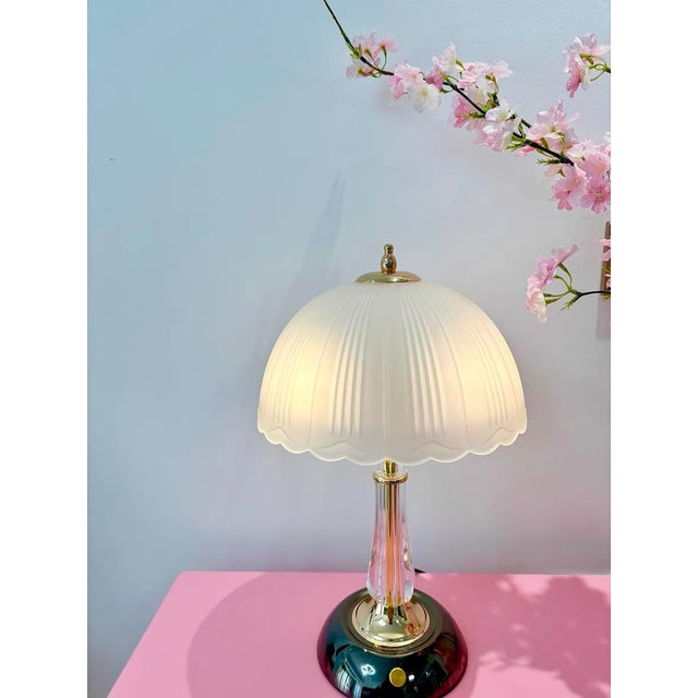 Soft-white vertical-texture shade (petal-shaped edge, small gold bead finial), transparent crystal + gilded trim lamp...