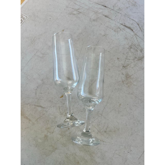 1960s champagne flute glasses. Clear Bowl & Stem by Rosenthal. The rim measures 1.75” in diameter. There is an uppercase...