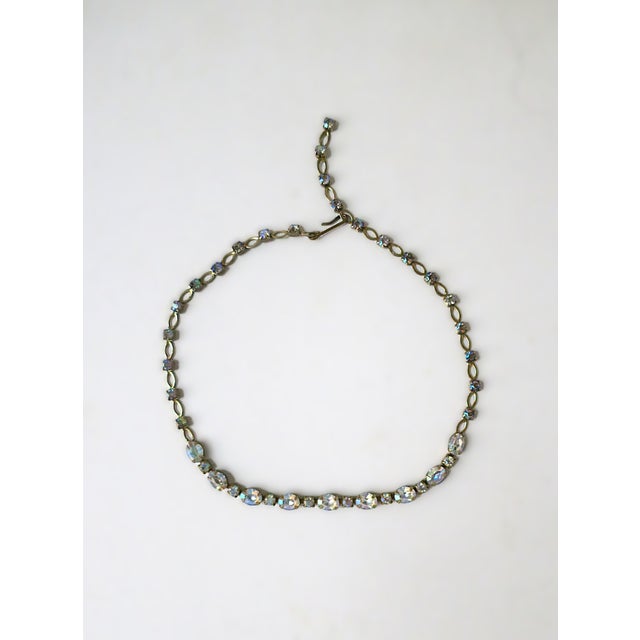A beautiful adjustable choker or collar length necklace with iridescent Rhinestones, circa early-20th century. Necklace is...