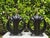 Striking pair of vintage sculptural ceramic table lamps in a glossy black finish. The bold, architectural forms have a...