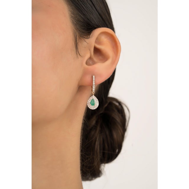 These drop earrings are feature 0.84 carats of pear cut emeralds set in 14K yellow gold. Each measuring approximately 6.24...