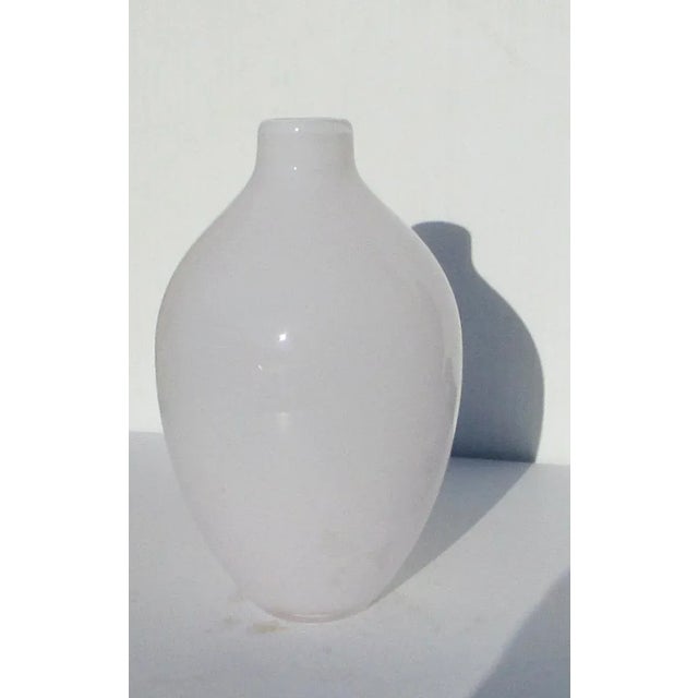 Opaelene white thick glass vase. Handmade with thick glass construction techniques that reflect deep blue shades over the...