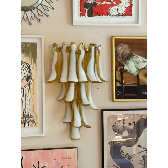 Pair of pink murano wall lamps consisting of sixteen glass prisms with lamp bases finishes and fittings in chrome. Glass...