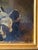 A charming early 20th century oil on canvas depicting a playful litter of spaniel puppies gathered in a woven basket...