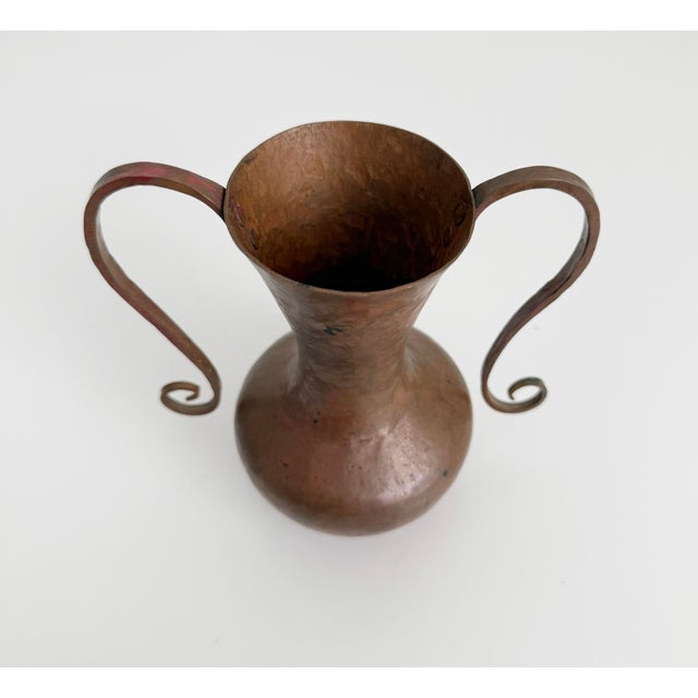 Beautiful, heavy copper vase produced in the Arts and Crafts era, late 1800s to early 1900s. Features thick hammered...