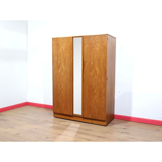 A stunning armoire made by renowned British furniture maker Austinsuite, this Mid Century Modern Vintage Teak Wardrobe...