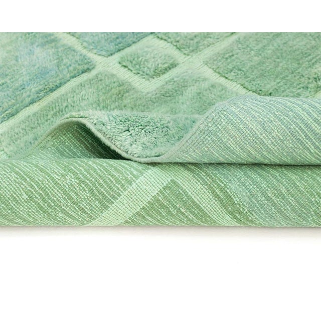 Vibrant hand-knotted rug in calming Emerald Green, with overlapping rectangles and squares creating a modern geometric...