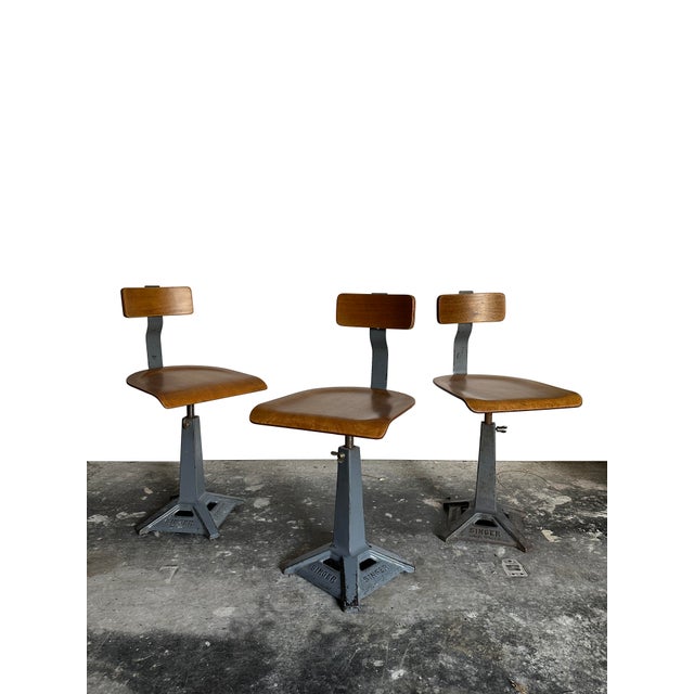 - A beautiful set of original Singer sewing chairs, England circa 1940. - The chairs feature a branded heavy die-cast iron...