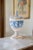 CAPODIMONTE CHERUB URN WITH LID Era: 1950s-1970s Maker: M.A.S. R. Capodimonte Origin: Italy OVERVIEW: A mid-century...