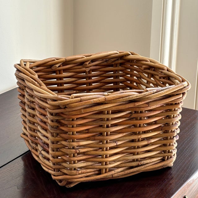 A charming petite vintage handwoven storage basket featuring a warm honey-colored patina developed over time. Crafted from...