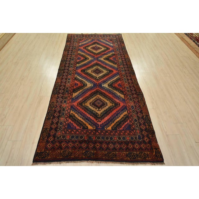 This authentic vintage tribal Baloch rug is hand-knotted with fine wool and natural dyes. This nomadic oriental rug...