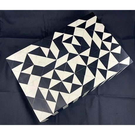 Safeguard your treasures with this exquisite inlaid wood box, featuring a striking black and white geometric pattern....