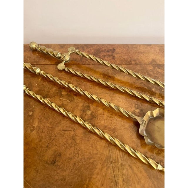 Quality antique Edwardian set of brass fire irons having a quality set of brass fire irons with ornate twisted brass...