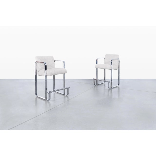 Mid-century modern chrome counter stools manufactured in the United States, circa 1970s. Defined by their sleek sled-base...