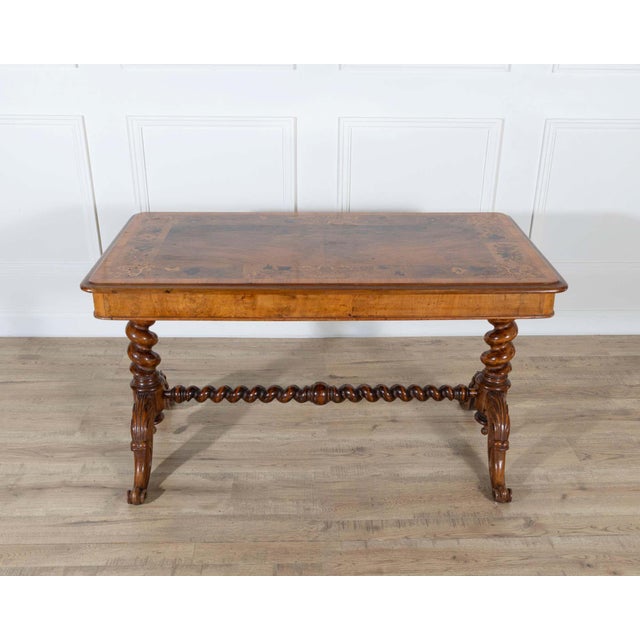 An elegant 19th-century Lombardy table, finely veneered in walnut and various precious woods, exemplifying the artistry...