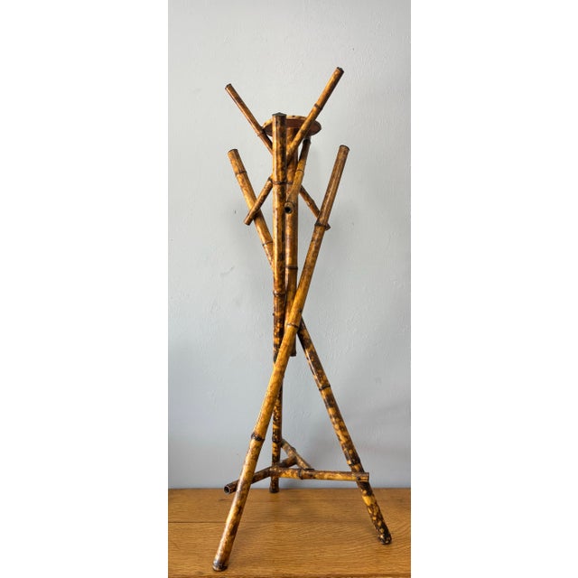 Light, sculptural, and quietly expressive, this late Victorian bamboo plant stand—often referred to as a jardinière...