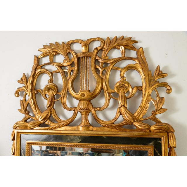 Just in, this large and Wonderfull Italian Louis XVI Style Carved Wood wall Mantel Mirror with a Gilded Finish and a faux...