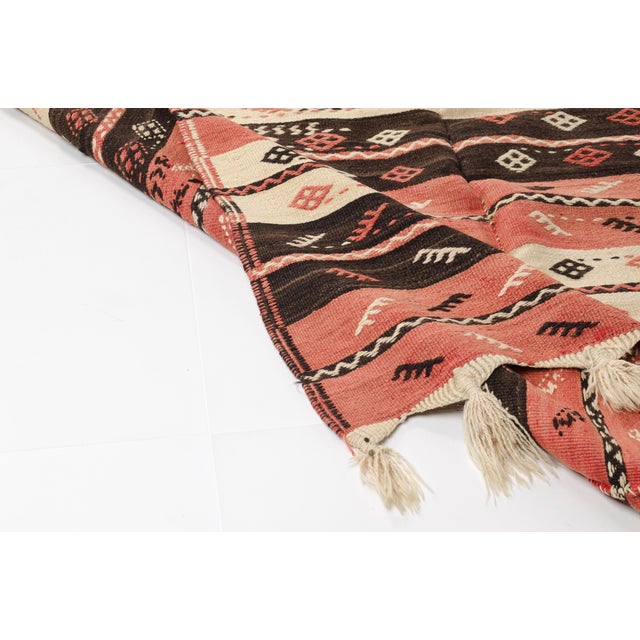 This is a vintage Turkish Oushak rug from the Mid 20th Century. The piece was hand-knotted.
