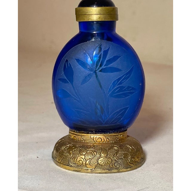 Up for sale is a rare antique handmade glass and bronze Chinese striker snuff bottle. The bottle is made of a thick cobalt...