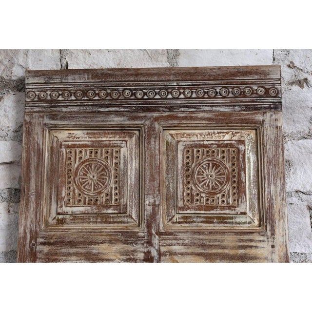 Make a bold artistic statement with this exquisite antique hand-carved wooden door, transformed into a striking barn door...